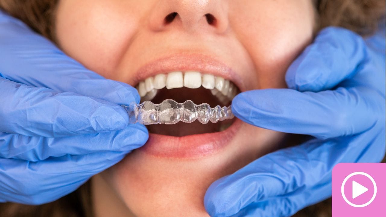 Gloved orthodontic assistant adjusting a patient's braces.